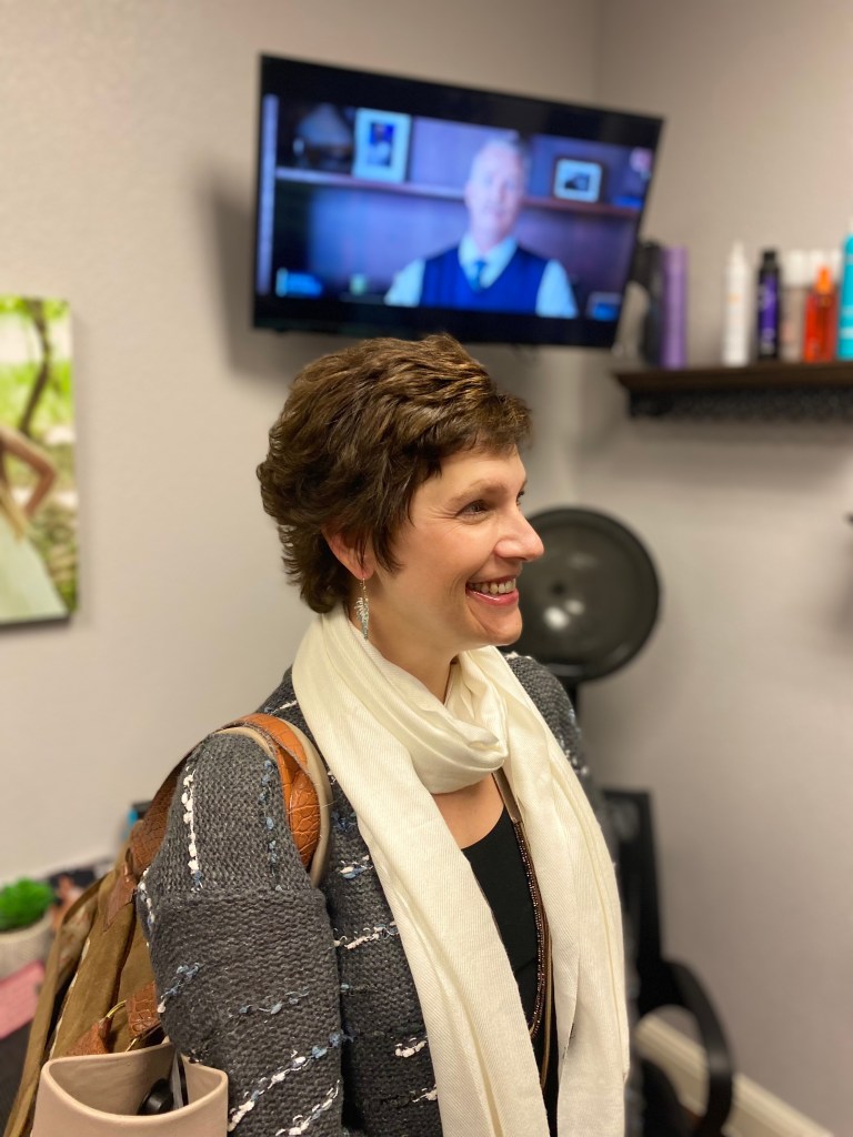 Cancer survivor receives first haircut after chemo hair regrowth