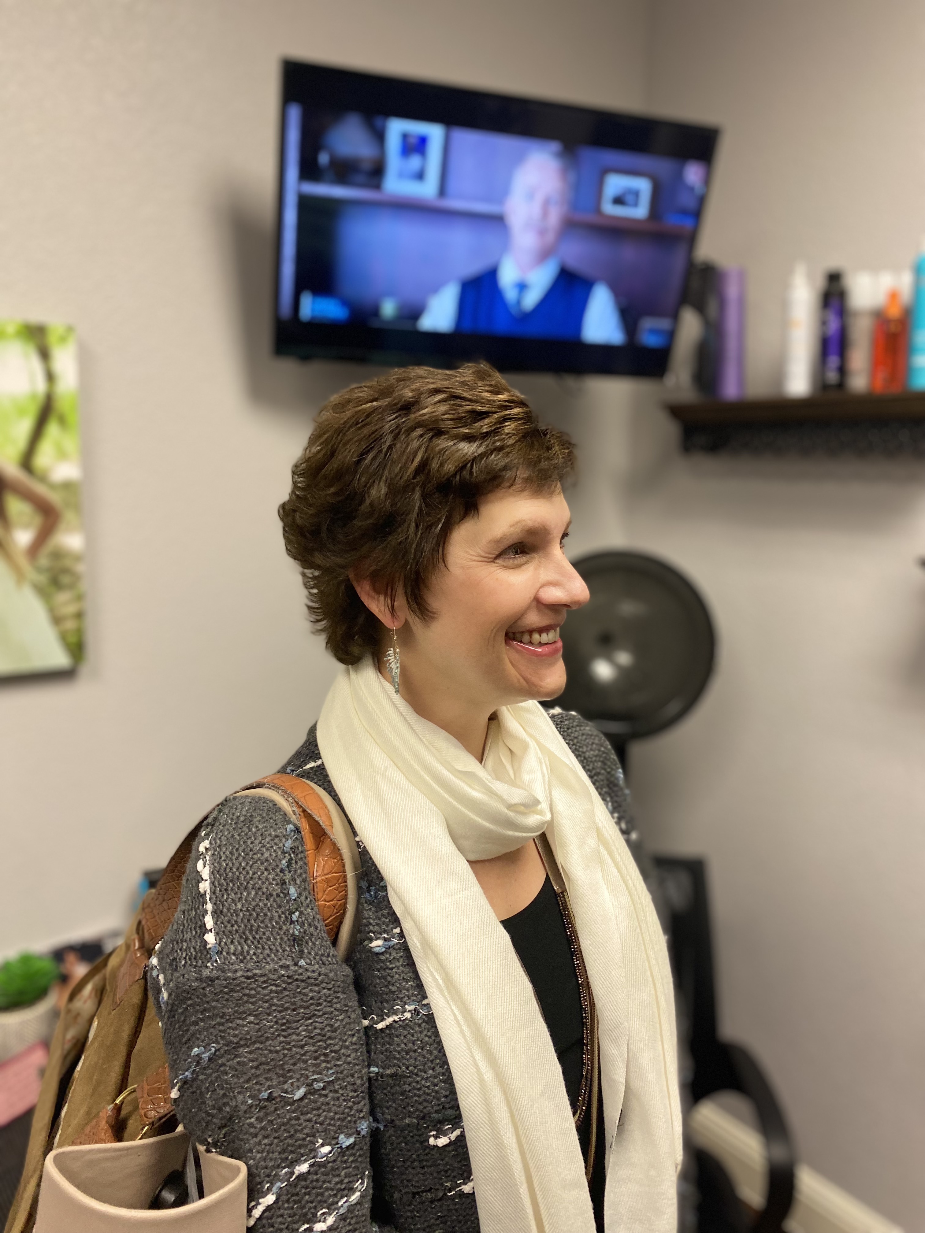 Cancer survivor receives first haircut after chemo hair regrowth