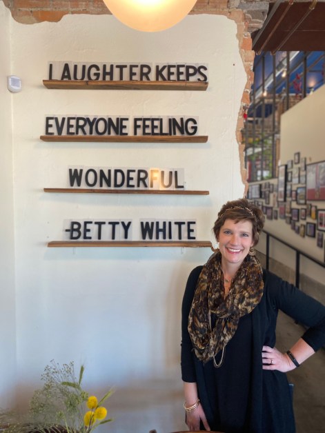 woman smiling by motivational quote from actress Betty White