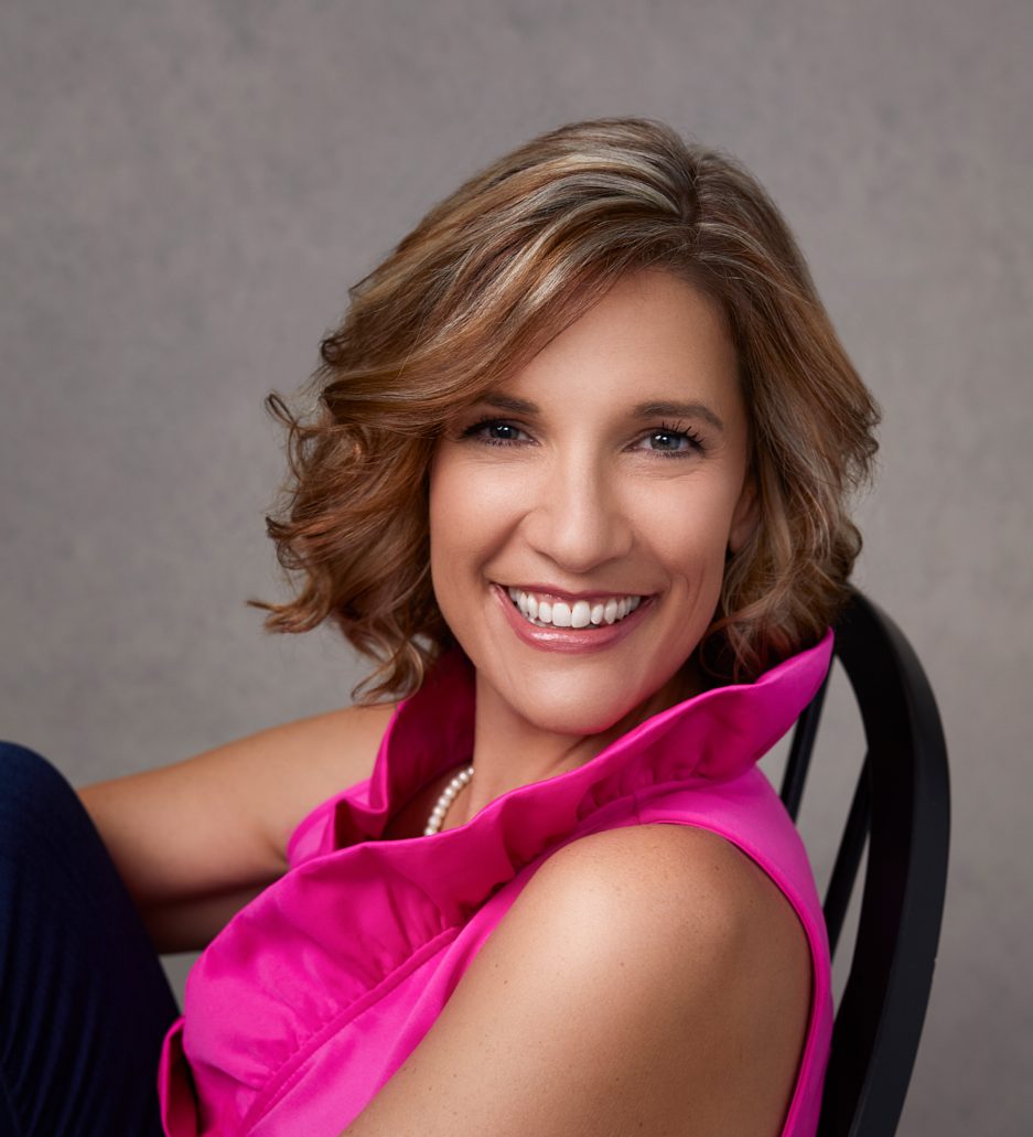 Young woman smiling in pink shirt