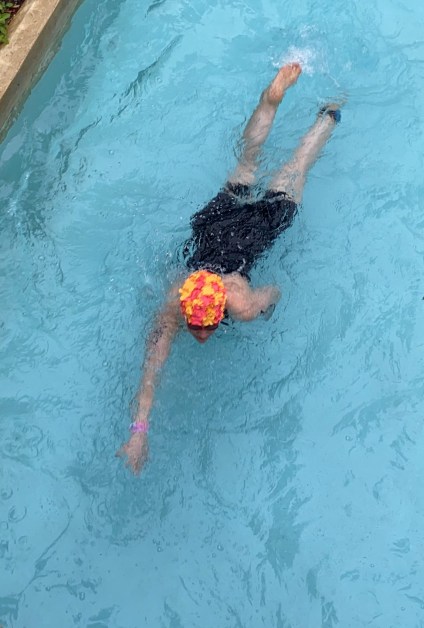Overhead shot of woman swimming freestyle